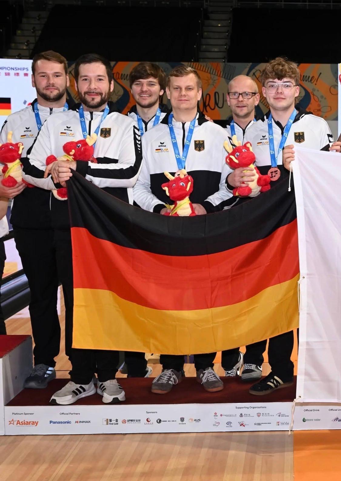 Mannschaftsfoto des deutschen Teams mit der Deutschlandflagge.