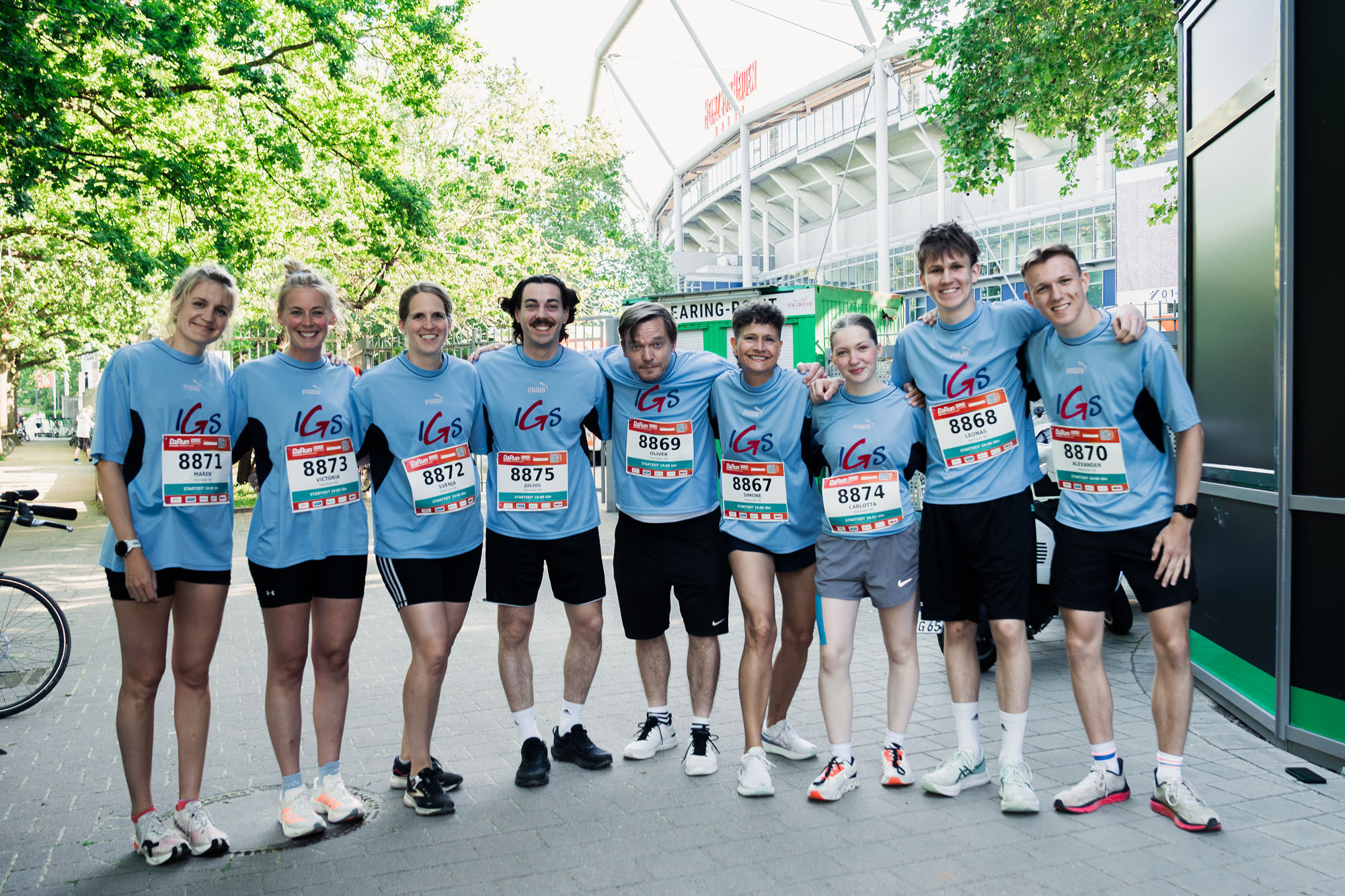 Gruppenbild einer Laufgruppe mit der Heinz von Heiden Arena im Hintergrund.