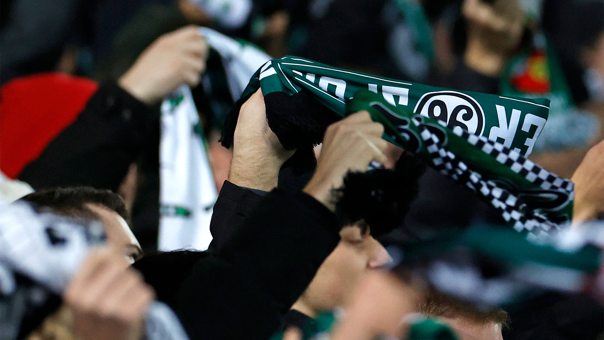 96-Fans schwenken Schals. 