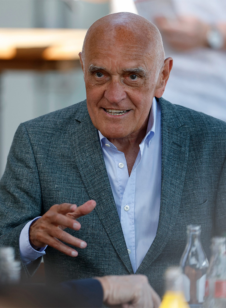 Martin Kind im grauen Sakko und Hemd gestikuliert.