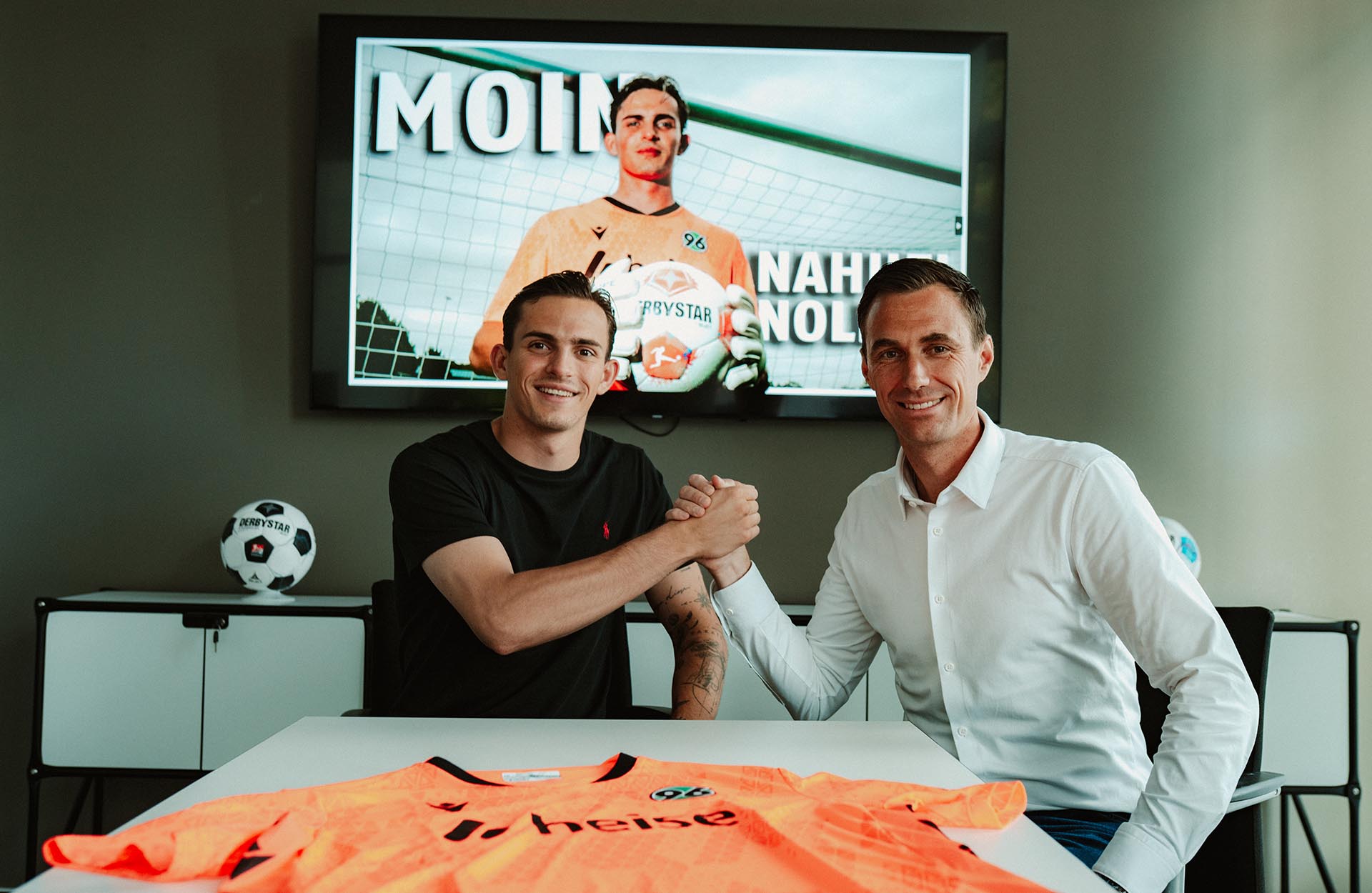 Hannover-96-Neuzugang Nahuel Noll beim Handshake mit 96-Geschäftsführer Marcus Mann in dessen Büro.