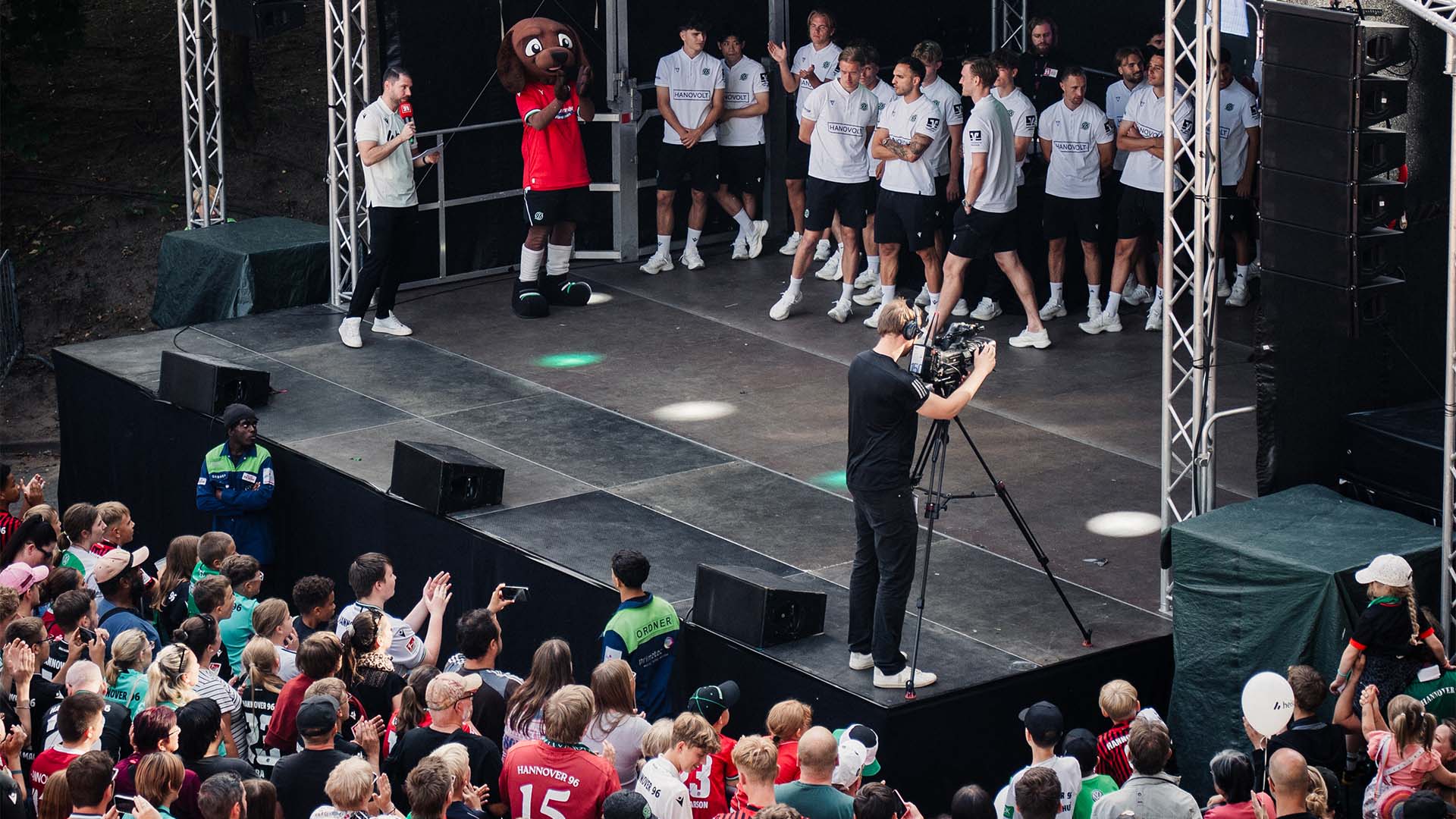 Die Mannschaft steht auf der Bühne, davor eine Menschenmenge.