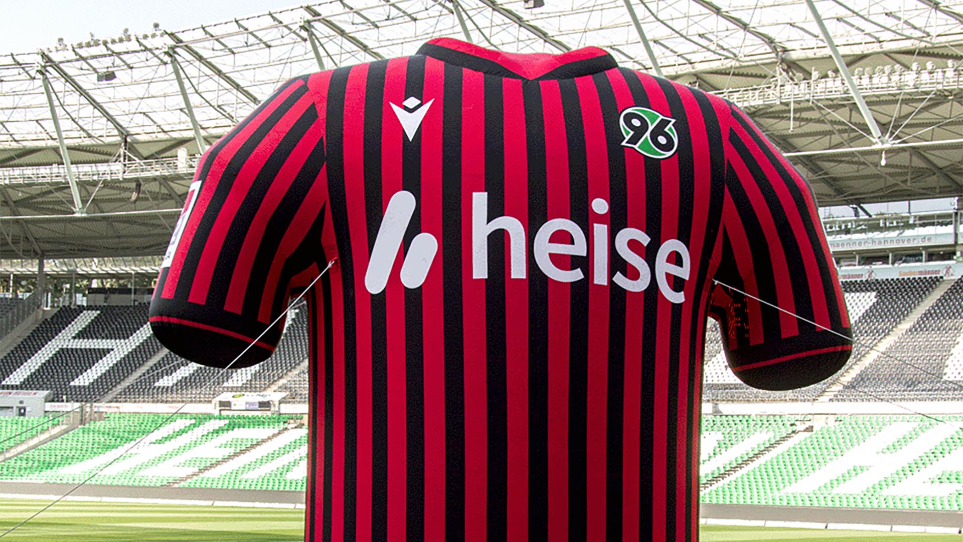 Ein aufgeblasenes XXL-Heimtrikot aus der letzten Saison steht im Stadion, im Hintergrund leere schwarz-weiß-grüne Tribünen.